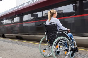 Symbolbild: Frau im Rollstuhl vor dem Zug – Bigstock